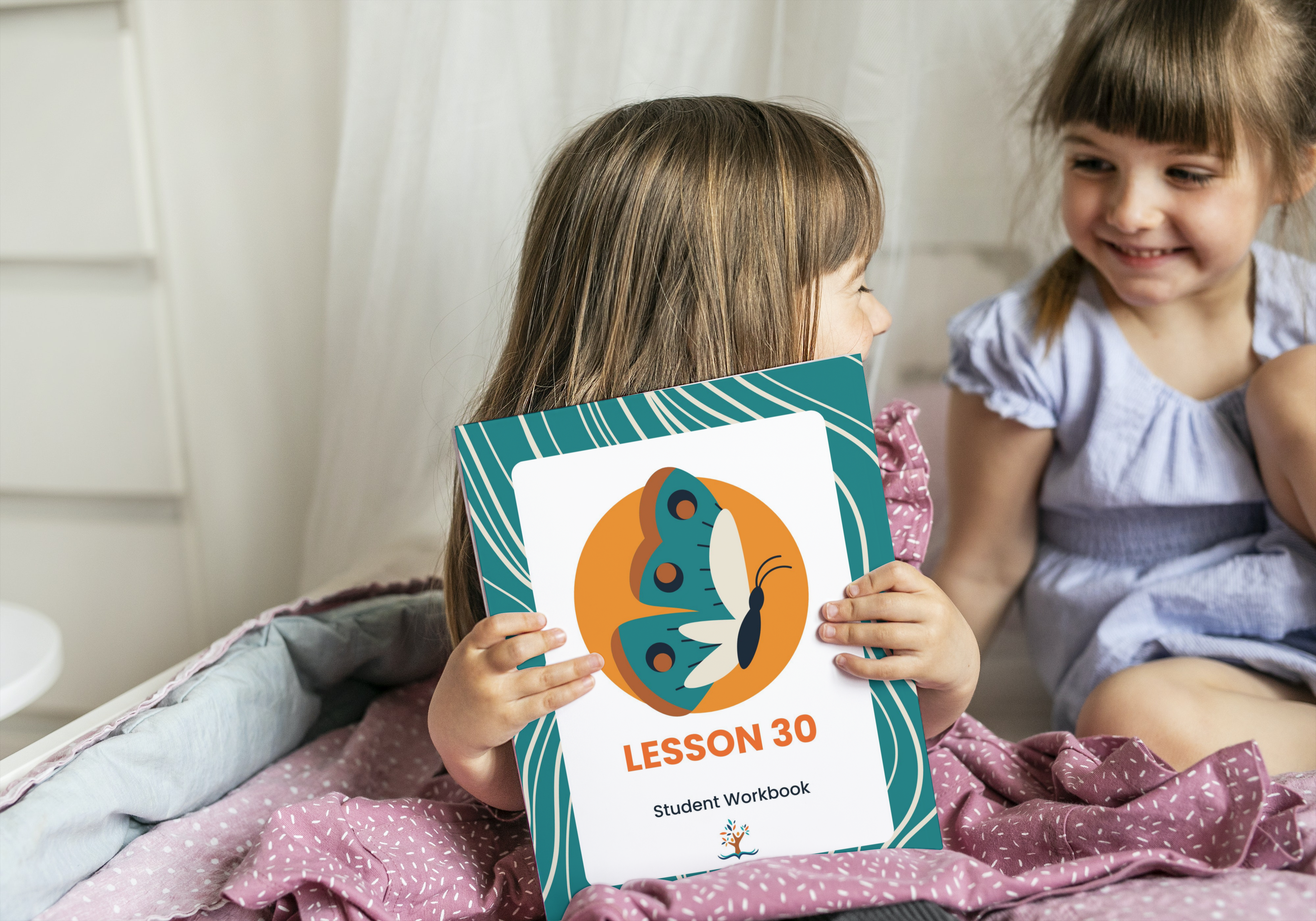 Two elementary school age girls reading a story.